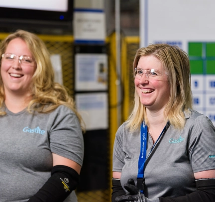 Two Females Smiling With Goggles