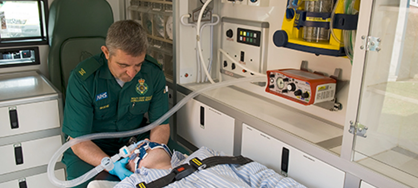 Paramedic with patient and ventilator