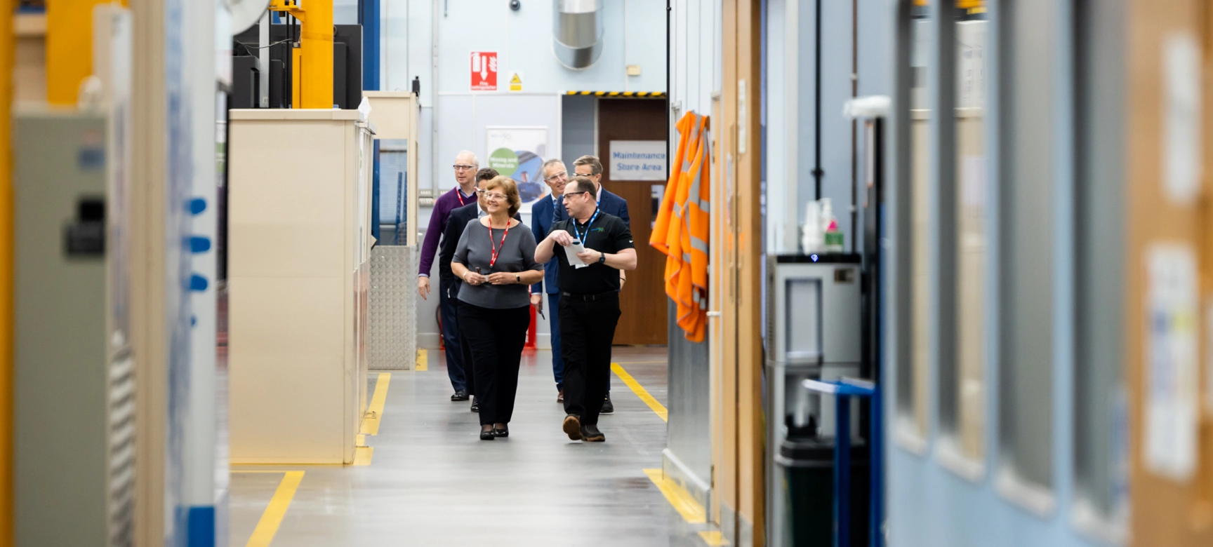 People Walking In Factory