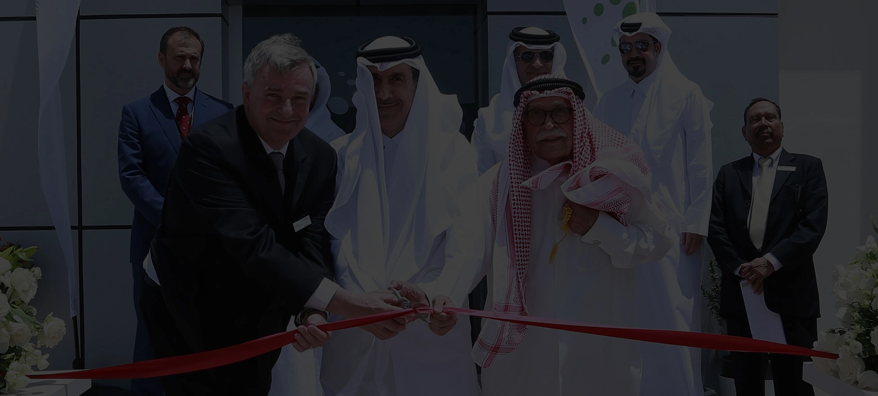 People cutting red ribbon